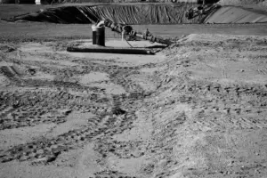 Industrial Ground Stabilization with Ocean Non - Monochrome image of construction site with visible tire tracks and a central