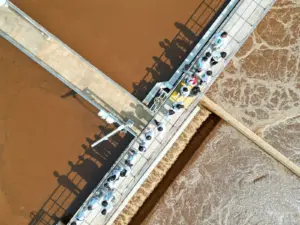 Case Study: Strengthening Environmental Protection Infrastructure - Aerial view of people touring an industrial water treatme